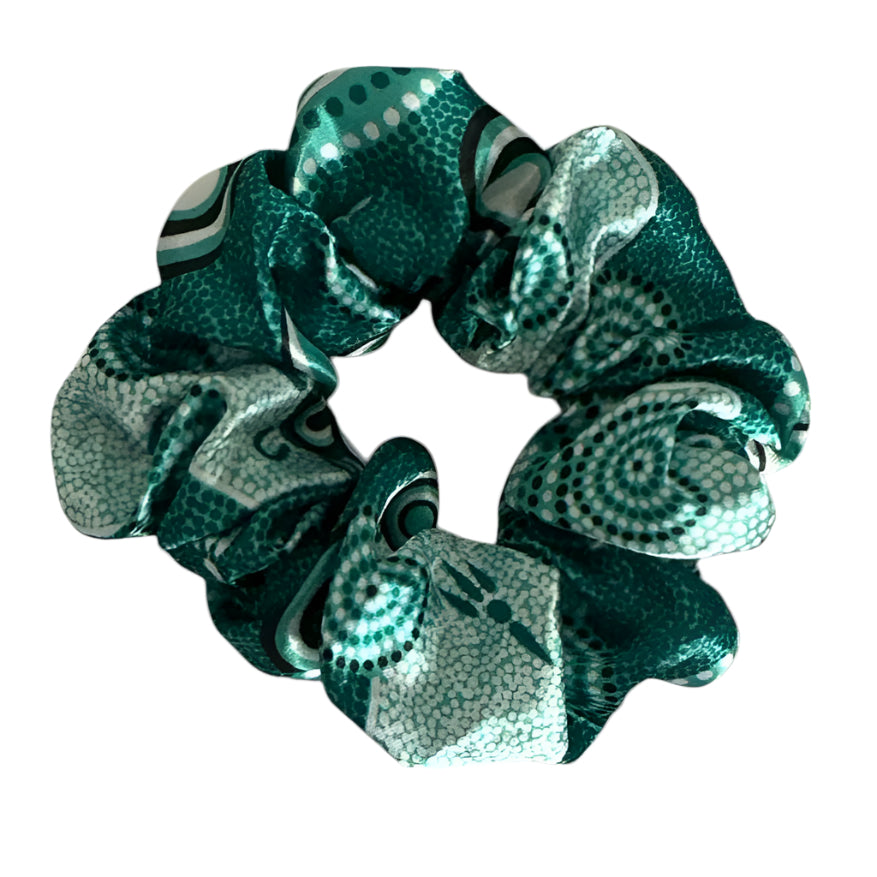 Teal scrunchie with pattern on a white background