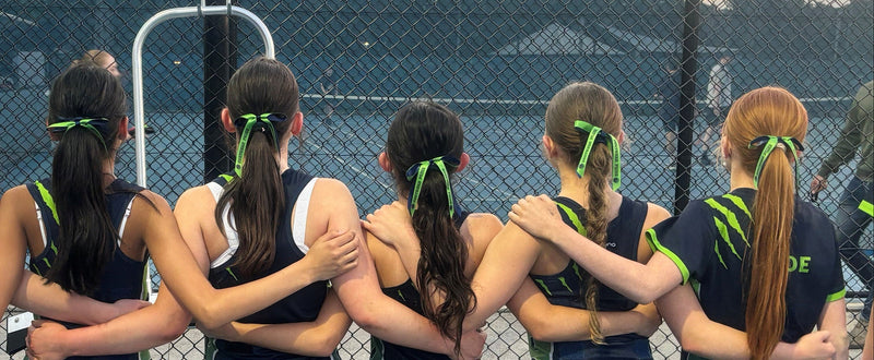 Group of female athletes with braided hair bows
