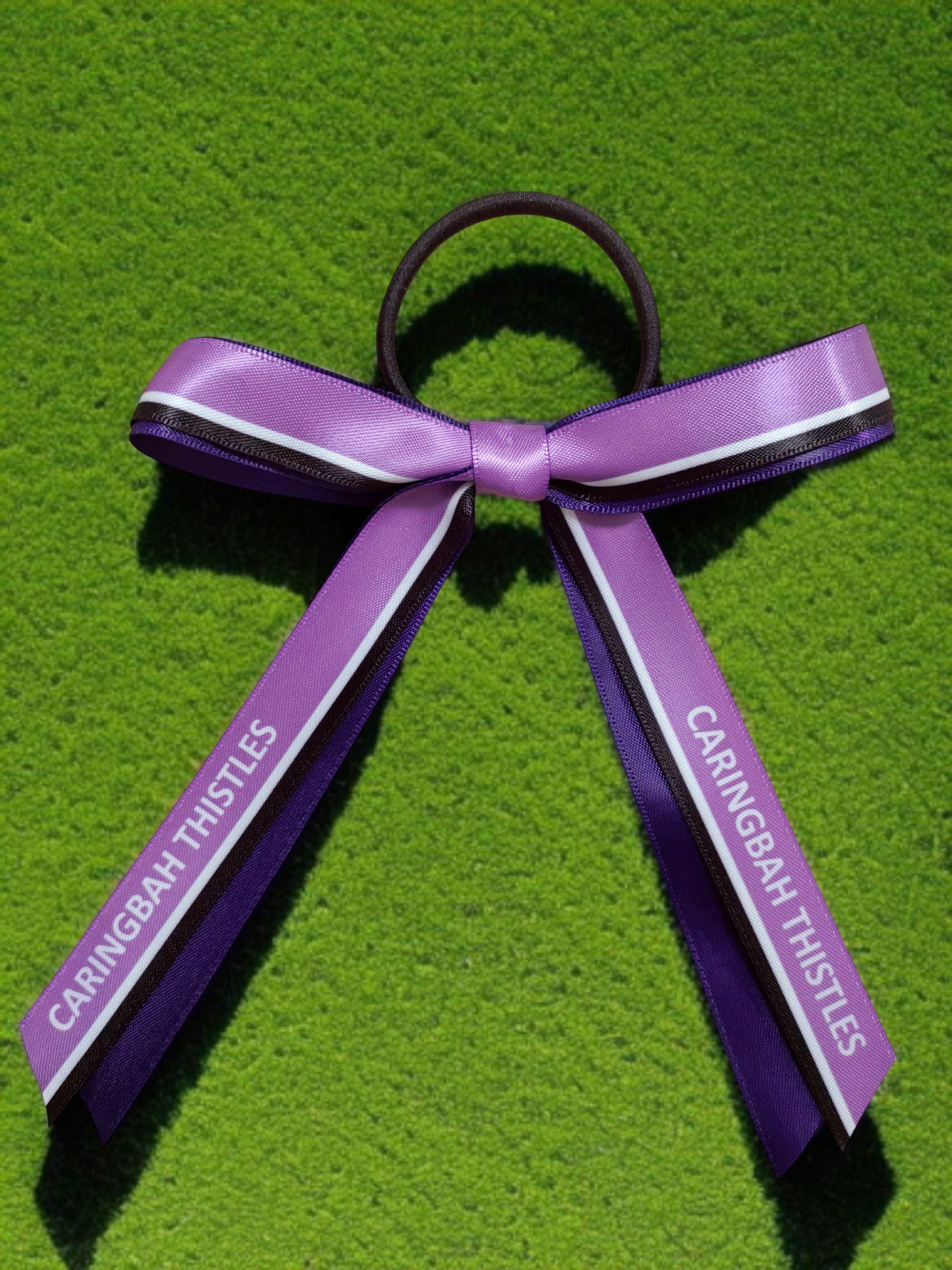 Purple ribbon text on a green background