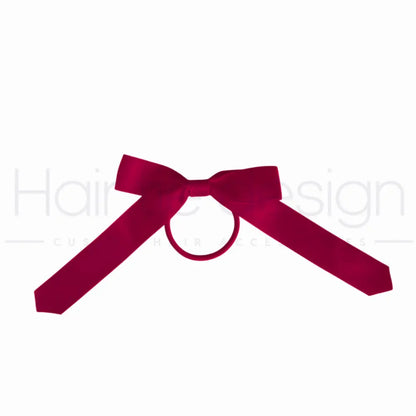 A deep magenta satin bow with a central loop, shown on a plain white background.