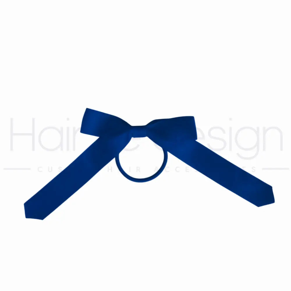 A royal blue satin bow tie with a central ring, displayed on a solid white background.